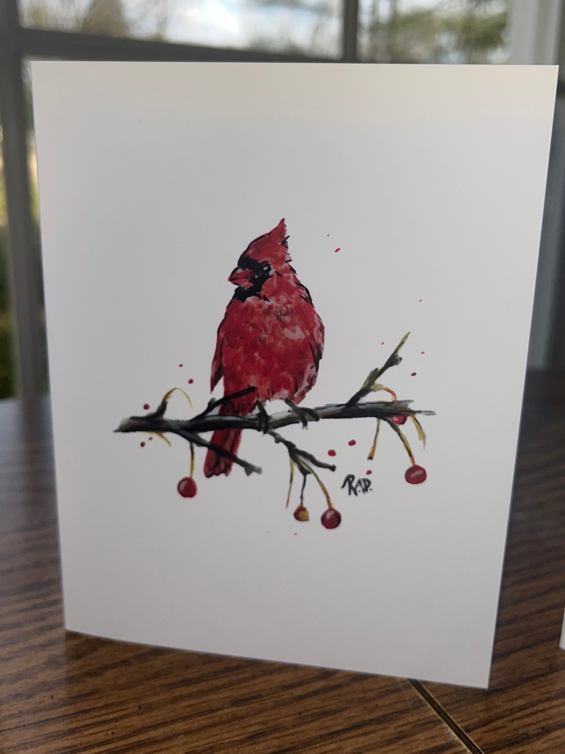 Card with a red cardinal bird illustration on a white background